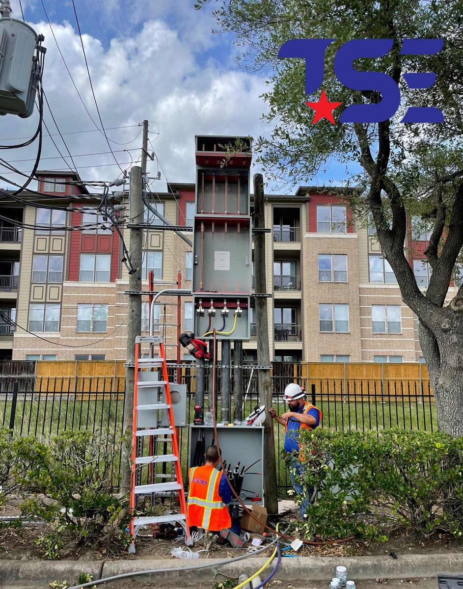 Tex-Star electricians working on a service entrance at an apartment complex