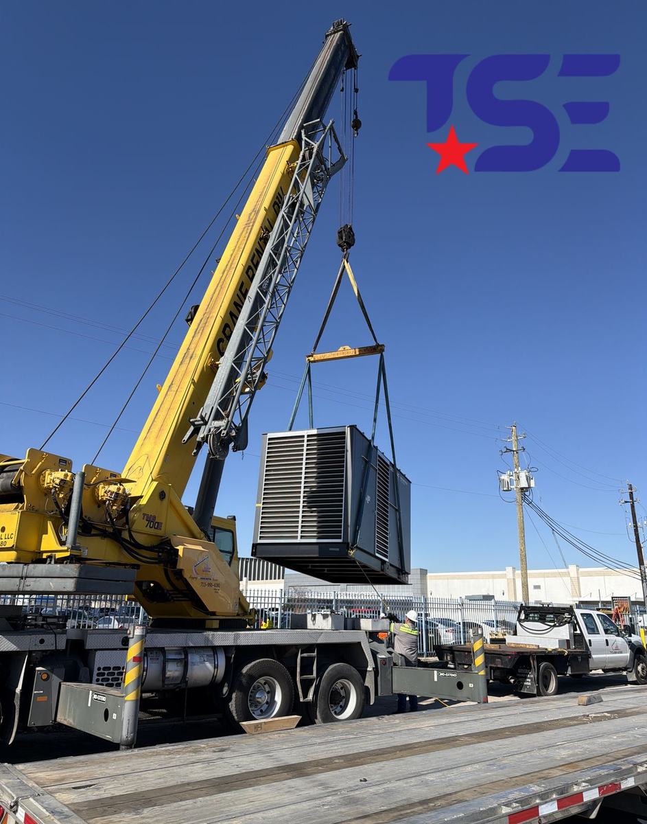 Crane setting a commercial generator into place