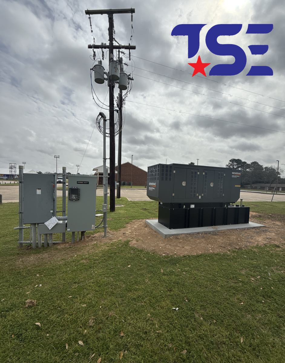 Industrial standby generator installed beside utility service and transfer equipment