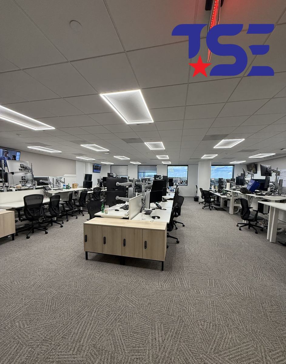 Completed open-office workspace with LED panel lighting