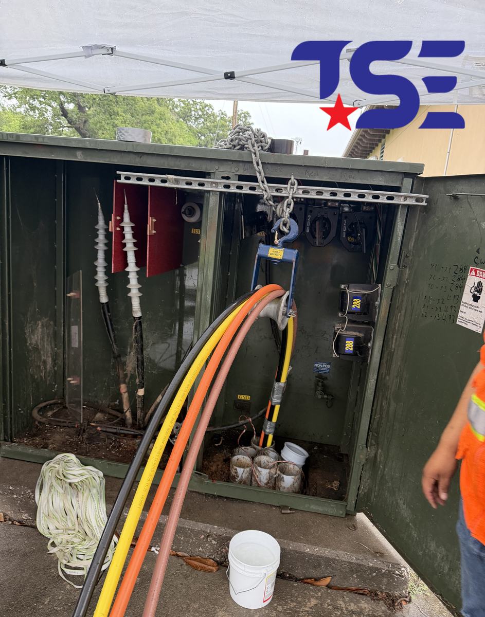 Electrician terminating cables in a pad-mount transformer